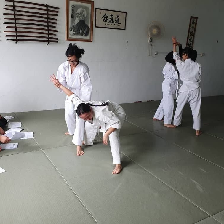 Students practising Aikido techniques in the dojo